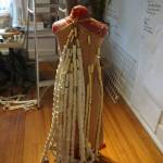 A dress made of sewing thread spindles, shown here Saturday, Oct. 14, 2017 in Homer, Alaska, is one of the Wearable Arts pieces being worked on by participants in a workshop Sheila Wyne held at Bunnell Street Arts Center in October. Wyne is artist in residence at Bunnell at a residency sponsored by the Homer Fiber Arts Collective. (Photo by Michael Armstrong)