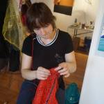 Mallory Drover works on a Wearable Arts piece Saturday, Oct. 14, 2017 at a workshop with Sheila Wyne at the Bunnell Street Arts Center in Homer, Alaska. She tore apart fruit bags as dress material. Drover is a Homer student and a visual arts major attending Antioch College, Yellow Springs, Ohio. She took Wyne&rsquo;s workshop as part of work study at Antioch. (Photo by Michael Armstrong)