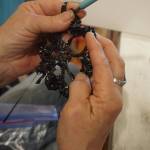 Linda Robinson crochets cassette tape film into flowers for a Wearable Arts piece Saturday, Oct. 14, 2017 at a workshop with Sheila Wyne at Bunnell Street Arts Center in Homer, Alaska. (Photo by Michael Armstrong)