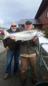 Ed Scribner holds up his 24.60 pound king salmon in the 2017 Homer Elks #2127 Winter King Salmon Derby. Scribner took first place fishing on the F/V Sea Wolf. Behind him is Don Fritz from Soldotna. Rough seas didn&rsquo;t keep anglers from braving Kachemak Bay for a chance to win the Elks Lodge derby, held Oct. 7-8. Ron Johnson took second with a 22.20-pound king on the F/V Oly John and Patrick Hankins was third with a 20.40-pound king on the F/V Sound Escape. Bethany Casey had a 20.30-pound king on the F/V Misty, winning first place for the lady angler division. With only 175 anglers, including women, 84 fish caught and 793.45 weighed, this year&rsquo;s derby was down from 2016, when 204 anglers caught 372 fish for a total weight of 3,350 pounds. Proceeds from the $100 per angler entry fees help support Elks youth, veterans and community charity programs. (Photo provided)