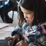 Fifth grader McKenna Carlin uses her classroom computer to do some research during a special lesson taught retired McNeil Canyon teacher Bill Noomah on Thursday, Oct. 19, 2017 at West Homer Elementary School in Homer, Alaska. The lesson, created from a collection in the Veterans History Project at the Library of Congress, is meant to teach students about Veterans Days as well as how to use primary sources in investigations. (Photo by Megan Pacer/Homer News)
