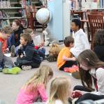 Eighth graders from Homer Middle School and first graders from Paul Banks Elementary debrief after working together on a project on sound during a lesson at the middle school Tuesday, Oct. 24, 2017 in Homer, Alaska. The lesson was organized through a mentorship program recently finalized between teachers at the two schools in which the younger students are paired with and learn from the older. (Photo by Megan Pacer/Homer News)