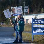 Lou Pontious waves signs for Charlie Pierce on Tuesday afternon, Oct. 24, 2017, in Homer, Alaska, on the Homer Bypass near Lake Street. (Photo by Michael Armstrong, Homer News)