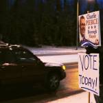 A car passes supporters waving signs for borough mayoral candidate Charlie Pierce at the intersection of the Sterling Highway and the Kenai Spur Highway on Tuesday, Oct. 24, 2017 in Soldotna, Alaska. Kenai Peninsula voters chose between Pierce and candidate Linda Hutchings for the office of borough mayor on Tuesday. (Photo by Elizabeth Earl/Peninsula Clarion)