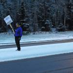 A man waves a sign supporting Kenai Peninsula Borough mayoral candidate Linda Hutchings from the median on the Sterling Highway near the intersection with the Kenai Spur Highway on Tuesday, Oct. 24, 2017 in Soldotna, Alaska. Kenai Peninsula voters chose between Hutchings and candidate Charlie Pierce in the mayoral runoff election Tuesday. (Photo by Elizabeth Earl/Peninsula Clarion)