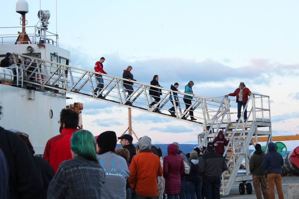 Fresh from being frightened, a group of people walks down off the U.S. Coast Guard Cutter Hickory while dozens more wait in line for this year&rsquo;s Haunted Hickory event Thursday, Oct. 26, 2017 in Homer, Alaska. Last year, about 1,000 people queued up at the Homer Spit to take a spooky tour of the ship, which the crew spends about two days transforming. (Photo by Megan Pacer/Homer News)