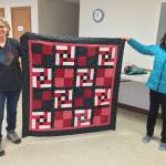 Members of the Kachemak Bay Quilters work with their quilts (Photo provided)