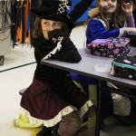 West Homer Elementary student Harmony Turner raises her hand during lunch at the school Tuesday, Oct. 31, 2017 in Homer, Alaska. Several area schools had costume parades or other Halloween celebrations. (Photo by Megan Pacer/Homer News)