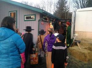 Costumed trick-or-treaters file into a makeshift haunted house Tuesday, Oct. 31, 2017 hosted by Kenai Physical Therapy in Homer, Alaska. Staff converted a trailer into a haunted house, which kids had to make it through in order to get their candy. (Photo by Anna Frost for the Homer News)