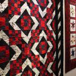 The Kachemak Bay Quilters spend a lot of their time creating quilts for victims of house fires, like the ones shown here during a First Friday exhibit Friday, Nov. 3, 2017 at the Homer Council on the Arts in Homer, Alaska. (Photo by Megan Pacer/Homer News)