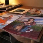 Paintings by Oceana Wills, a local artist and commercial fisherman, rest on a table at her home for the winter Friday, Nov. 10, 2017 in Kachemak City, Alaska. (Photo by Megan Pacer/Homer News)