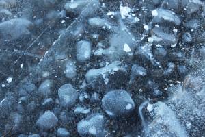 Pockets of air are shown trapped in the ice Wednesday, Nov. 15, 2017 on Beluga Lake in Homer, Alaska. (Photo by Megan Pacer/Homer News)