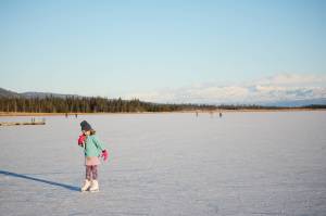 Pinky Sarber skates on Beluga Lake last Friday afternoon, Nov. 17, 2017 in Homer, Alaska. With clear and cold weather, the lake has frozen enough to support ice skating. A slight dusting of snow last Thursday didn&rsquo;t affect skating. (Photo by Michael Armstrong, Homer News)