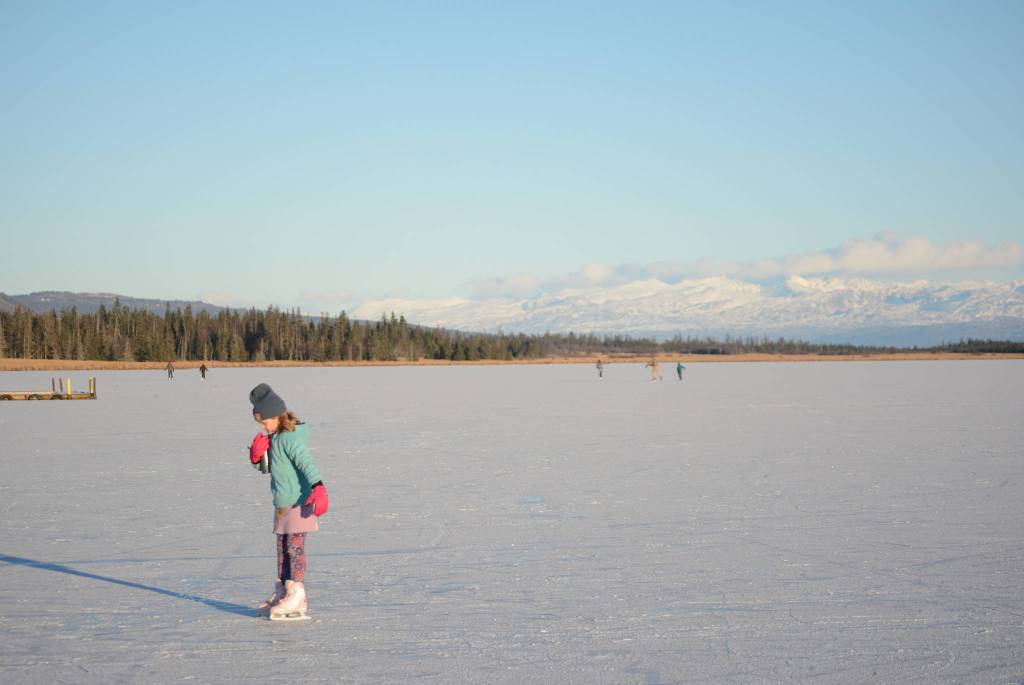 Pinky Sarber skates on Beluga Lake last Friday afternoon, Nov. 17, 2017 in Homer, Alaska. With clear and cold weather, the lake has frozen enough to support ice skating. A slight dusting of snow last Thursday didn&rsquo;t affect skating. (Photo by Michael Armstrong, Homer News)