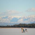 Skaters glide across Beluga Lake last Friday afternoon, Nov. 17, 2017 in Homer, Alaska. With clear and cold weather, the lake has frozen enough to support ice skating. A slight dusting of snow last Thursday didn&rsquo;t affect skating. (Photo by Michael Armstrong, Homer News)