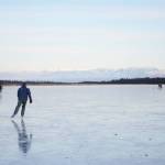Skaters glide across Beluga Lake last Wednesday afternoon, Nov. 15, 2017 in Homer, Alaska. With clear and cold weather, the lake has frozen enough to support ice skating. A slight dusting of snow last Thursday didn&rsquo;t affect skating. (Photo by Michael Armstrong, Homer News)