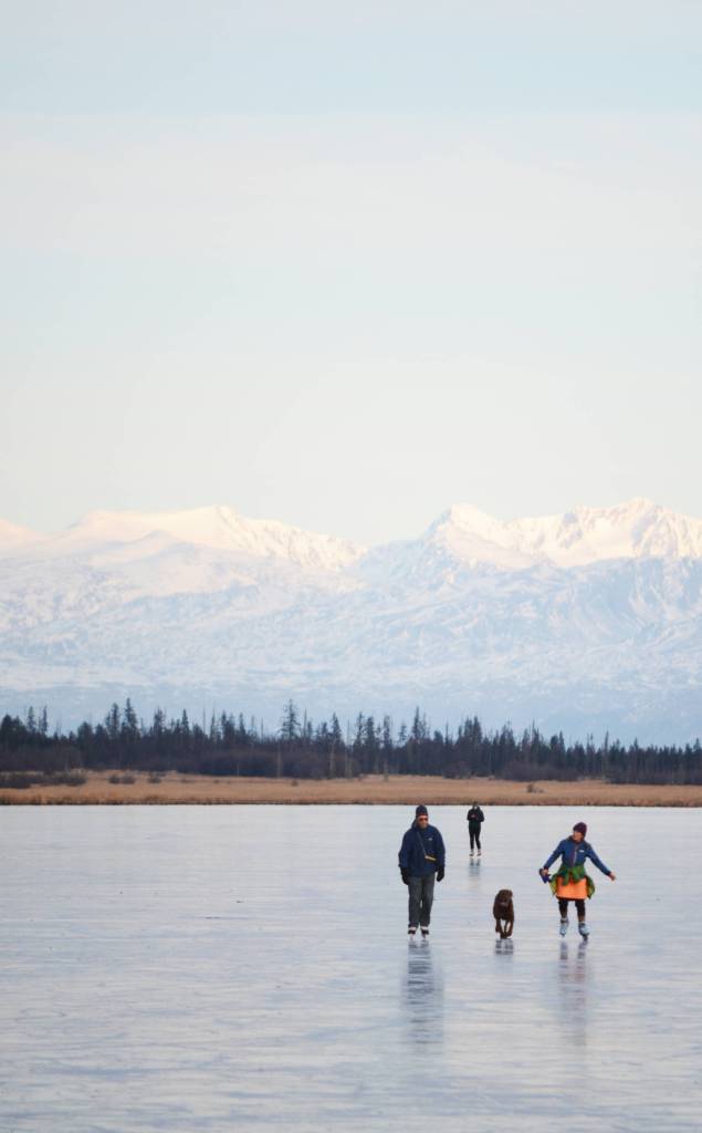 Skaters glide across Beluga Lake last Wednesday afternoon, Nov. 15, 2017 in Homer, Alaska. With clear and cold weather, the lake has frozen enough to support ice skating. A slight dusting of snow last Thursday didn&rsquo;t affect skating. (Photo by Michael Armstrong, Homer News)