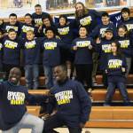 Chris Mburu, left, takes a selfie with Kimani Nyambura in front of several students from Port Graham School during a presentation there Thursday, Nov. 16, 2017 in Port Graham, Alaska. The pair spoke to students from four peninsula schools about the importance of education. Mburu and Nyambura are both from the same small village in Kenya, and were able to attend school through sponsorship. Mburu is not a human rights lawyer working for the United Nations. (Photo by Megan Pacer/Homer News)