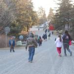 Students and faculty from Port Graham School run through the village as part of a presentation by visiting human rights lawyer Chris Mburu, who works for the United Nations, and Kimani Nyambura on Thursday, Nov. 16, 2017 in Port Graham, Alaska. The pair visited and spoke to several Kenai Peninsula schools on Nov. 16-17 about their journey through education from a small village in Kenya and Mburu&rsquo;s creation of a foundation to help Kenyan children go to school. (Photo by Megan Pacer/Homer News)
