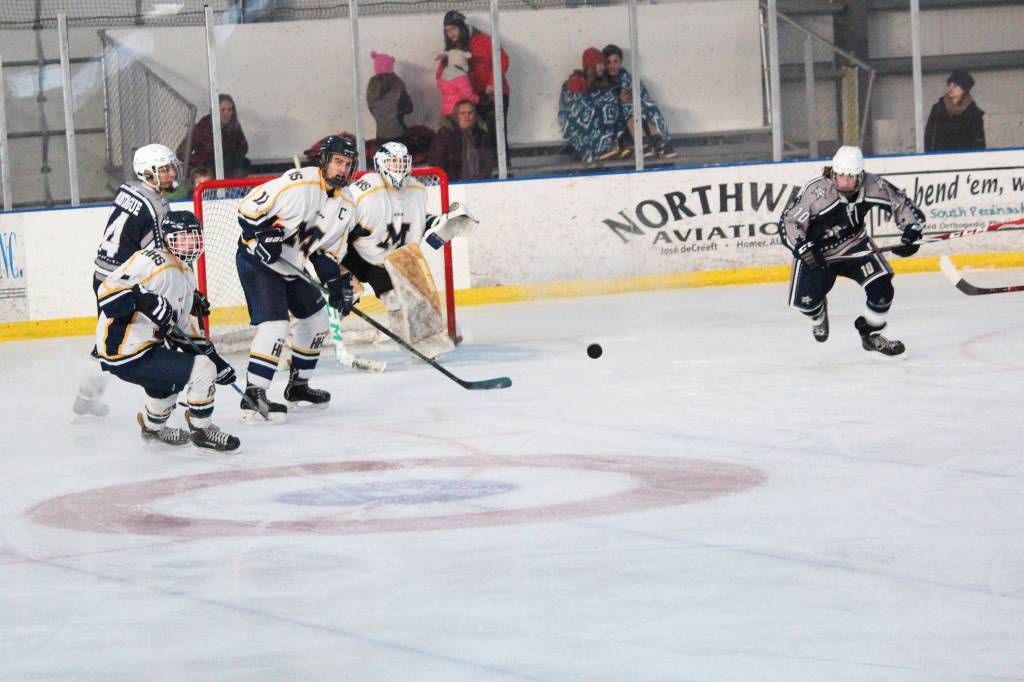 Photo by Megan Pacer/Homer News Homer&rsquo;s Charlie Menke, a senior, passes the puck during the Mariners&rsquo; game against Soldotna High School on Saturday, Nov. 18 at the Kevin Bell Arena in Homer. The Mariners beat the Stars 10-3 and won the End of the Road Tournament.