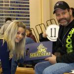 Breeanna Torsen, left, poses for a photo with her dad, Brant &ldquo;Boog&rdquo; Torsen, in a December 2013 file photo for a Meet the Mariners fundraiser. (Homer News file photo)