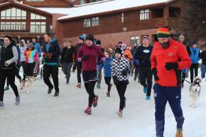 A crowd of Homer residents and several of their canine companions take off at the start of the 3rd Annual &ldquo;Sweating Gravy&rdquo; Turkey Trot 5K Fun Run/Walk on Thursday, Nov. 23, 2017 at Homer High School in Homer, Alaska. Hosted by the Kachemak Bay Running Club and the Community Recreation Program, the run is non- competitive and non-timed. To enter, participants donated two non-perishable food items, which were given to the Homer Food Pantry. (Photo by Megan Pacer/Homer News)