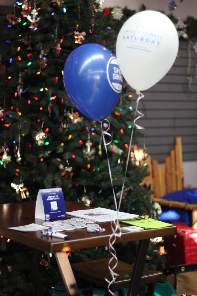 A Shop Small Saturday table set up by the Homer Chamber of Commerce sits ready with buttons, stickers and information during the small business promotion Saturday, Nov. 25, 2017 at NOMAR in Homer, Alaska. (Photo by Megan Pacer/Homer News)