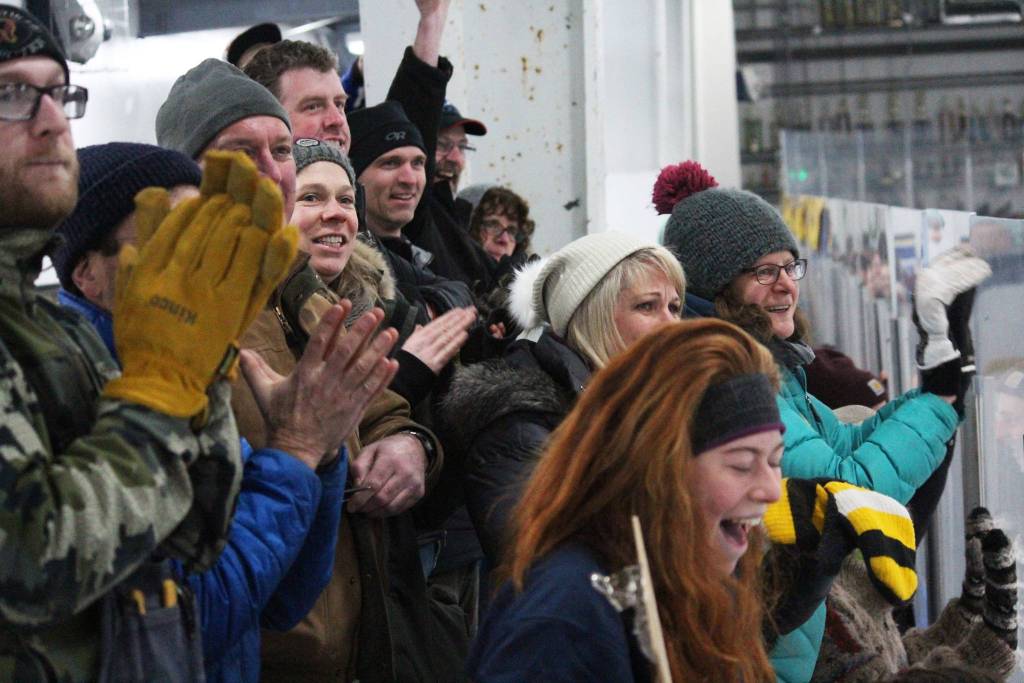 The crowd cheers shortly after the Homer High School hockey team scored its final goal in its game against Colony High School on Friday, Dec. 1, 2017 at Kevin Bell Arena in Homer, Alaska. Ethan Pitzman scored the winning goal with less than 11 seconds left on the clock in overtime. (Photo by Megan Pacer/Homer News)
