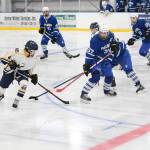 Homer&rsquo;s Lee Lowe tries to get the puck away from several Palmer High School skaters during their game Saturday, Dec. 2, 2017 at Kevin Bell Ice Arena in Homer, Alaska. The Mariners swept all three Mat-Su Valley teams they played over the weekend, moving to 3-0 in conference play. (Photo by Megan Pacer/Homer News)