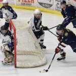 Homer skater Dimitry Kuzmin (right) pulls the puck around Soldotna goaltender Kenzie Powell Tuesday, Dec. 5, 2017 at the Soldotna Regional Sports Complex in Soldotna, Alaska. (Photo by Joey Klecka/Peninsula Clarion)