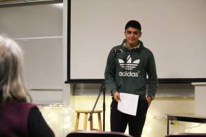 Pedro Ochoa, the assistant cross-country team coach, reads a sonnet he wrote during a Coffee House event held Tuesday, Dec. 5, 2017 at Pioneer Hall on Kachemak Bay Campus in Homer, Alaska. The event was put on by the school&rsquo;s Student Association and was an opportunity for student, many of whom were taking a creative writing class, to share their work aloud in public. (Photo by Megan Pacer/Homer News)