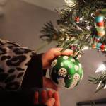 Pinky Sarber holds an ornament she made for a Christmas tree decorated by Paul Banks Elementary School students for a fundraiser Friday, Dec. 1, 2017 in Homer, Alaska benefitting South Peninsula Haven House. Young artists made the snowmen by tracing their fingers. Local nonprofits decorated trees that were auctioned off in a silent auction at a space Haven House uses for special events on Bunnell Avenue in Homer. (Photo by Michael Armstrong, Homer News)