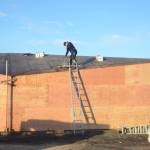 Photo by Michael Armstrong/Homer News Dave Louk of Last Frontier Roofing works last Friday on the roof of the new Boat House at the harbor near Ramp 2. The pavilion is under construction at the site of the old harbor office and when finished will provide shelter for harbor users.