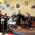 Members of the Homer Youth String Orchestra perform spread some holiday cheer at K-Bay Caffé on Saturday, Dec. 16, 2017 in Homer, Alaska. From left to right are Daniel Perry, Rosy Kauffman, Sylvia Clemens, Theodore Handley, Avram Salzmann and Clyde Clemens. (Photo provided)