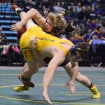Grace Christian&rsquo;s Evan Bockman flips Homer&rsquo;s Tristen Cook on his side in the 182-pound final Saturday night at the Division II state wrestling championships at the Alaska Airlines Center in Anchorage. (Photo by Joey Klecka/Peninsula Clarion)