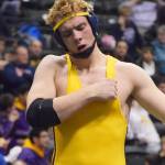 Levi King of Homer pounds his chest in celebration after winning the 195-pound Division II title Saturday night at the state wrestling championships at the Alaska Airlines Center in Anchorage. (Photo by Joey Klecka/Peninsula Clarion)