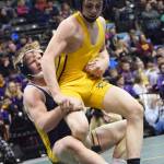 Monroe Catholic&rsquo;s Riley Rust (left) takes down Homer&rsquo;s Wayne Newman in the 126-pound final Saturday night at the Division II state wrestling championships at the Alaska Airlines Center in Anchorage. (Photo by Joey Klecka/Peninsula Clarion)