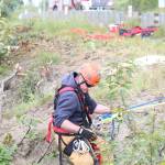 A member of Kachemak Emergency Services makes his way down the slope near Baycrest Overlook on Monday, July 24, 2017 in Homer, Alaska. First responders found a pickup truck that had fallen over the edge after hitting a guard rail on the Sterling Highway, and searched for a possible victim until getting a report that the driver had crashed several days earlier and had walked away uninjured. (Photo by Megan Pacer/Homer News)