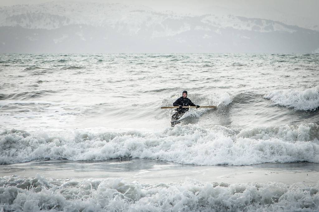 Bjorn Olson surfs off the Homer Spit in a traditional kayak. (Photo courtesy Bjorn Olson)