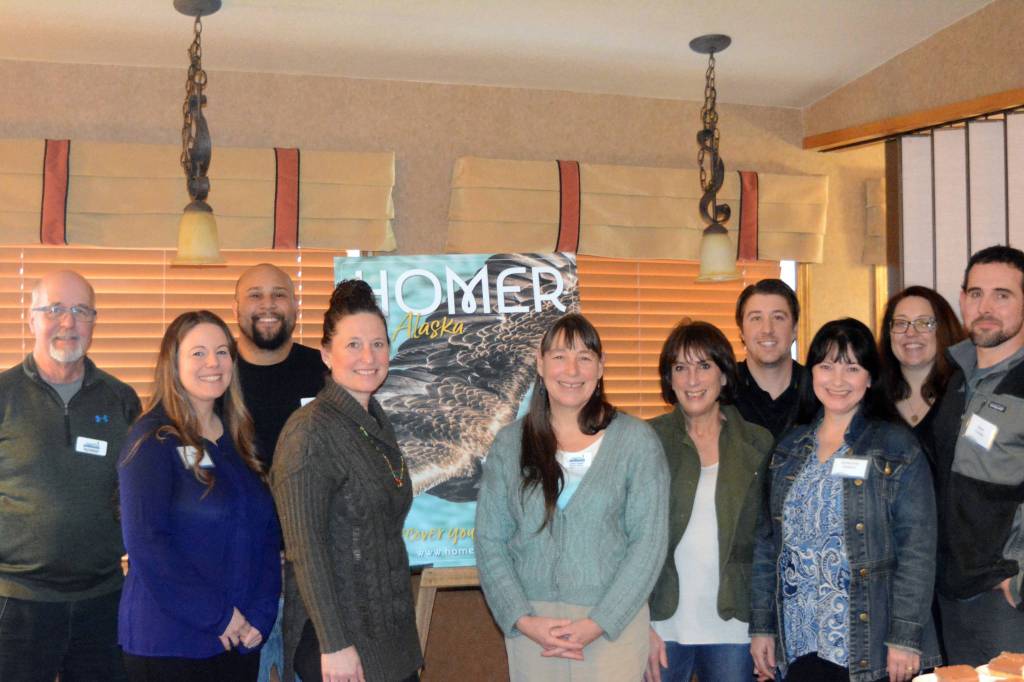 Photo by Michael Armstrong/Homer News New and returning members of the Homer Chamber of Commerce and Visitor Center board of director pose in front of a poster of the new chamber tourism guide after the chamber&rsquo;s annual meeting on Tuesday at the Best Western Bidarka Inn. From left to right are Tom Soderholm; Alita Martin; Nelton Palma; Kari Dendurent; Jenny Carroll, advisory member representing the City of Homer; Melanie Dufour; Patrick Mede; Adrienne Sweeney; Keri-Ann Baker, President; and Brad Conley. A full house of members attended the annual meeting. Chamber director Debbie Speakman introduced new and returning board members and announced the winners of the chamber&rsquo;s photo contest. Board President Baker also unveiled the cover of the 2018 tourism and recreation guide, with an image of a soaring eagle by photographer Collin Walker.