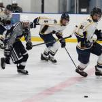 Homer hockey players Dimitry Kuzmin (12), Douglas Dean (5) and Charlie Menke (11) chase after the puck along with Soldotna&rsquo;s Alex Montague during their game Tuesday, Jan. 16, 2018 at Kevin Bell Arena in Homer, Alaska. The Mariners beat the Stars 10-1. (Photo by Megan Pacer/Homer News)