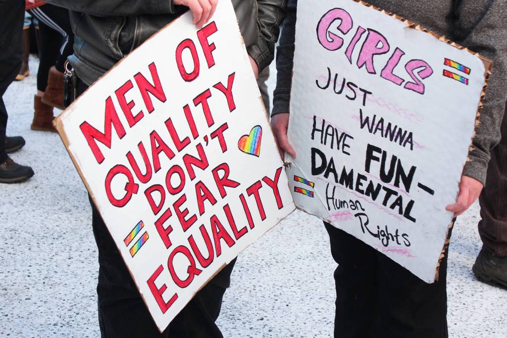 Marchers prepare to spread their messages through the streets of Homer as they gather in the HERC parking lot before the Women&rsquo;s March on Homer 2018 sets off down Pioneer Avenue on Saturday, Jan. 20, 2018 in Homer, Alaska. (Photo by Megan Pacer/Homer News)