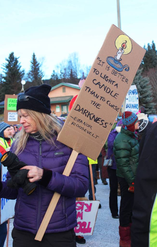 A Homer area woman with a sign bearing a quote by Eleanor Roosevelt prepares to march with hundreds of others in the HERC Building parking lot ahead of the Women&rsquo;s March on Homer 2018 on Saturday, Jan. 20, 2018 in Homer, Alaska. (Photo by Megan Pacer/Homer News)