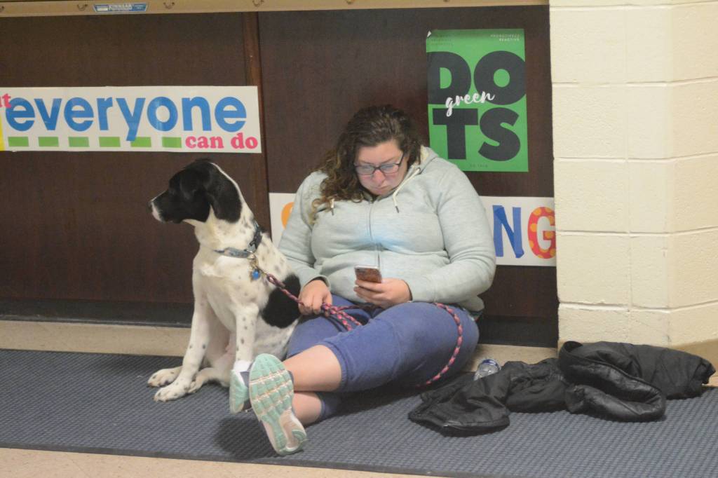 Anna Dale and her dog Poppy wait at Homer High School during a tsunami evacuation early Tuesday. About 50 cars and trucks &mdash; including a few motorhomes &mdash; parked at Homer High School during the tsunami evacuation. Another 40 people and four dogs and two cats waited inside. (Photo by Michael Armstrong, Homer News)