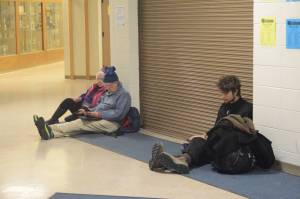 Jan Knutson, left, and Ed Hutchinson wait at Homer High School during a tsunami evacuation early Tuesday. About 50 cars and trucks Ѡincluding a few motorhomes Ѡparked at Homer High School during the tsunami evacuation. Another 40 people and four dogs and two cats waited inside. (Photo by Michael Armstrong, Homer News)