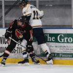 Kenai Central High School&rsquo;s Jakeb Obrien holds Homer senior Charlie Menke against the wall during their game Thursday, Jan. 25, 2018 at the Kevin Bell Arena in Homer, Alaska. The Mariners beat the Cardinals 6-5 in a tight game, their last at home. (Photo by Megan Pacer/Homer News)