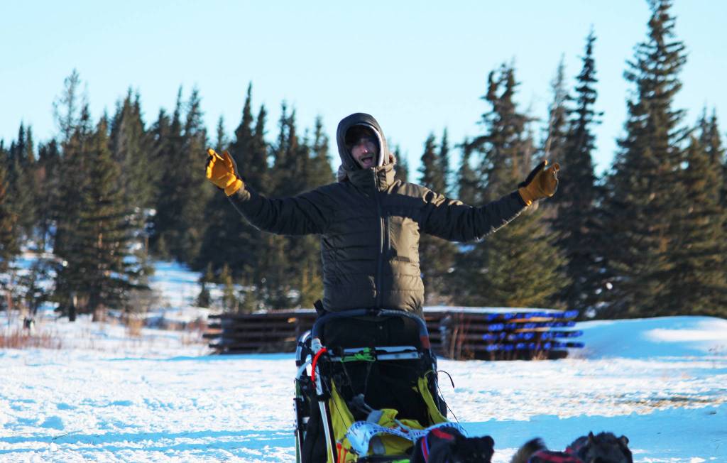 Musher Nicolas Petit raises his arms in celebration as he crosses the finish line of the Tustumena 200 Sled Dog Race in first place Sunday, Jan. 28, 2018 at Freddie&rsquo;s Roadhouse in Ninilchik, Alaska. The win marked Petit&rsquo;s third in a row this season, but was his first victory in the T200. (Photo by Megan Pacer/Homer News)