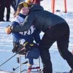 Angelica Haakenson receives a hug from Homer assistant coach Megan Corazza Friday afternoon in the Kenai Klassic races at the Tsalteshi Trails in Soldotna. (Photo by Joey Klecka/Peninsula Clarion)