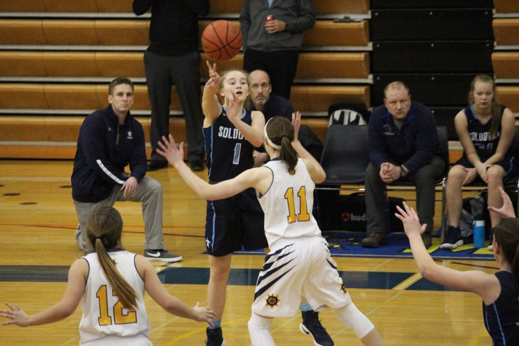 Soldotna High School junior Kalyn McGillivray passes the ball under pressure from Homer&rsquo;s Grace Godfrey during their game against the Homer High School varsity girls basketball team Tuesday, Jan. 30, 2018 in the Alice Witte Gymnasium in Homer, Alaska. (Photo by Megan Pacer/Homer News)