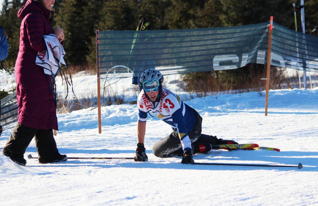 Homer&rsquo;s Denver Waclawski stands back up after sliding to the ground when he crossed the finish line of the varsity boys&rsquo; 5 kilometer skate ski race Saturday, Feb. 3, 2018 at the Lookout Mountain Ski Trails near Homer, Alaska. Waclawski raced Soldotna&rsquo;s Jode Sparks to a photo finish to claim sixth place. (Photo by Megan Pacer/Homer News)